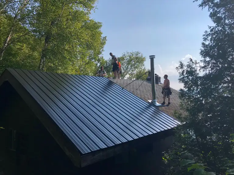 A completed Roofing For Less steel roof installation